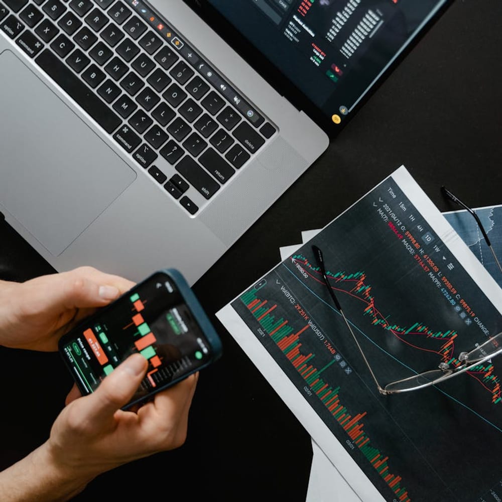 Hands holding a smartphone displaying travel data on screen viewed from above