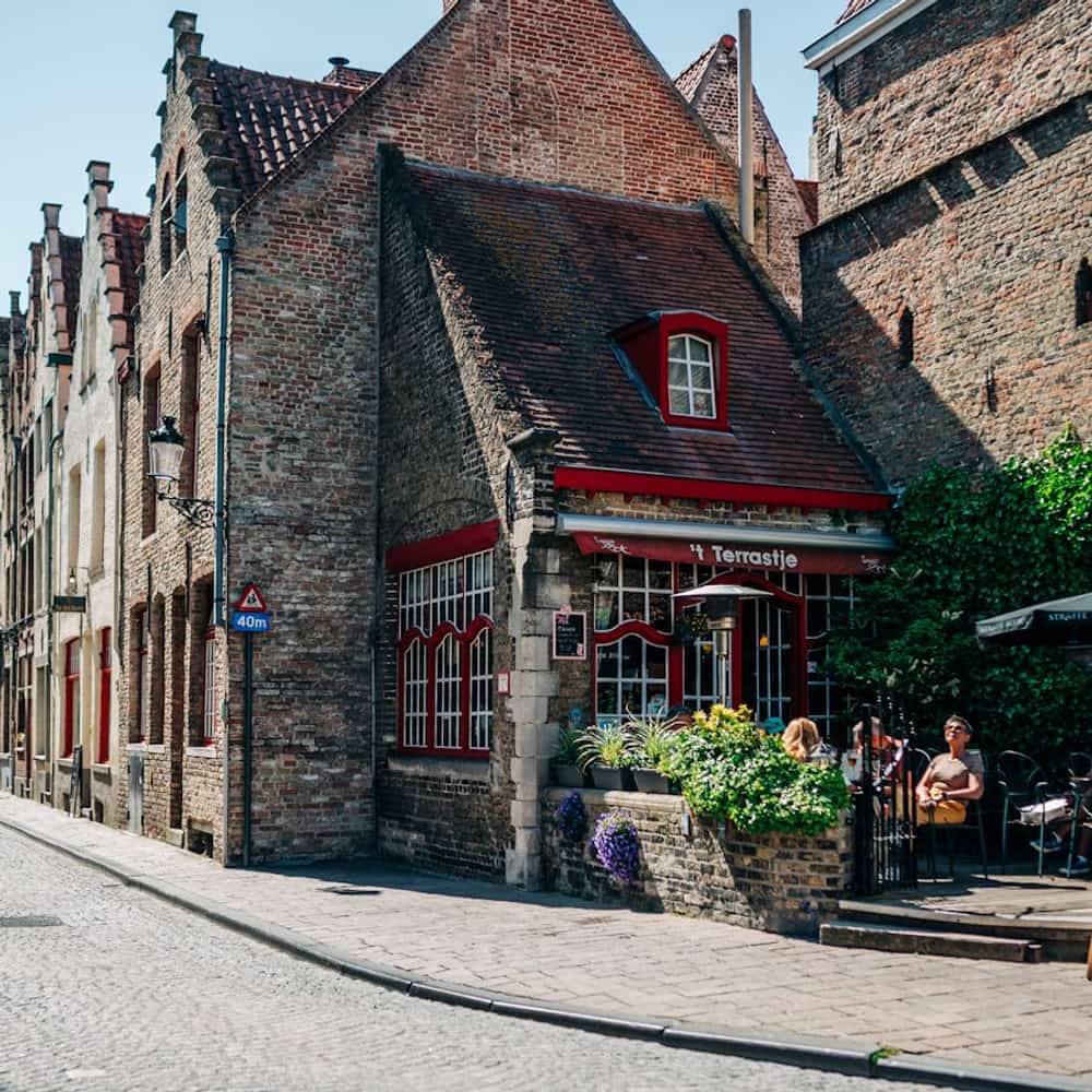 Historic European alley with brick buildings and cobblestone street in old town
