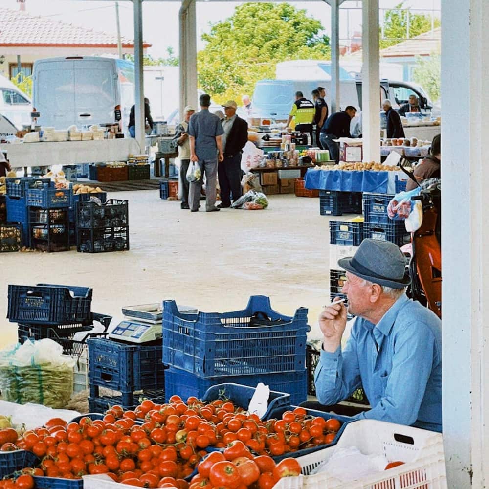 Open-air farmers market stall with fresh colorful produce and local ingredients