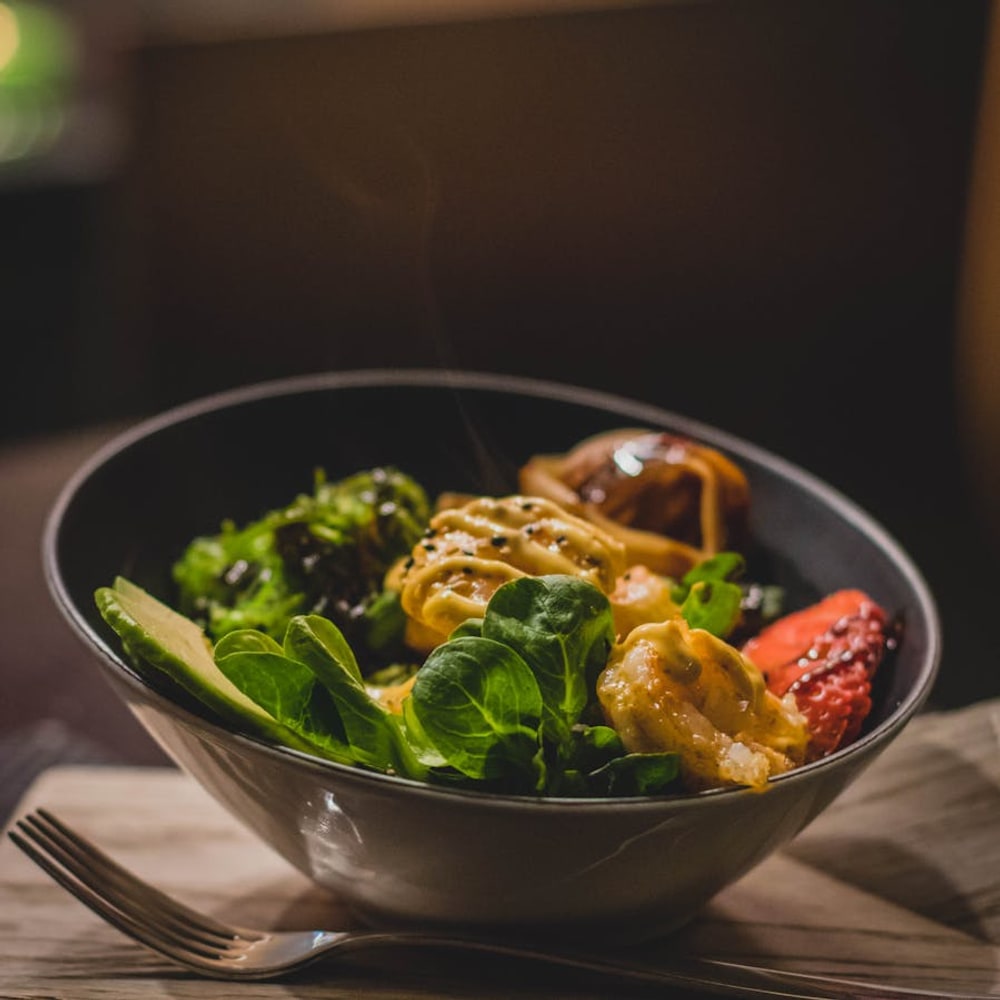 Appetizing close-up of a colorful plated meal with glossy sauce and fresh garnish