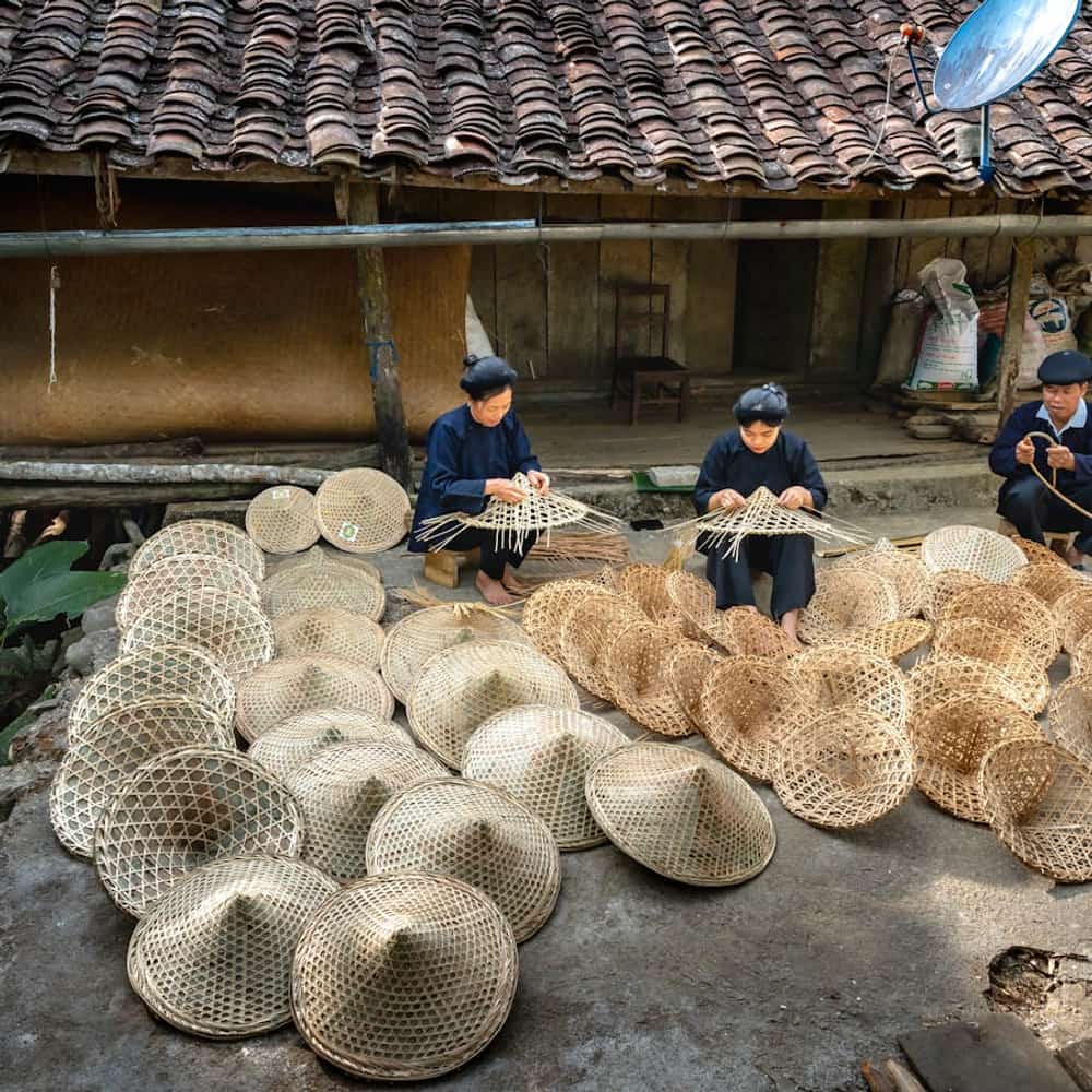 Artisan practicing traditional basket weaving in a rural workshop with handcrafted materials