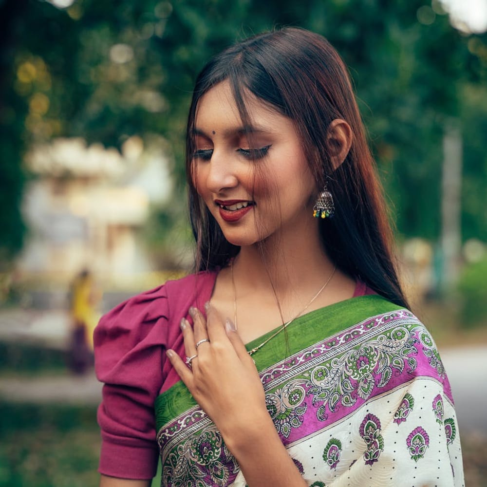 Woman wearing an elegant traditional Bengali saree outdoors in natural daylight