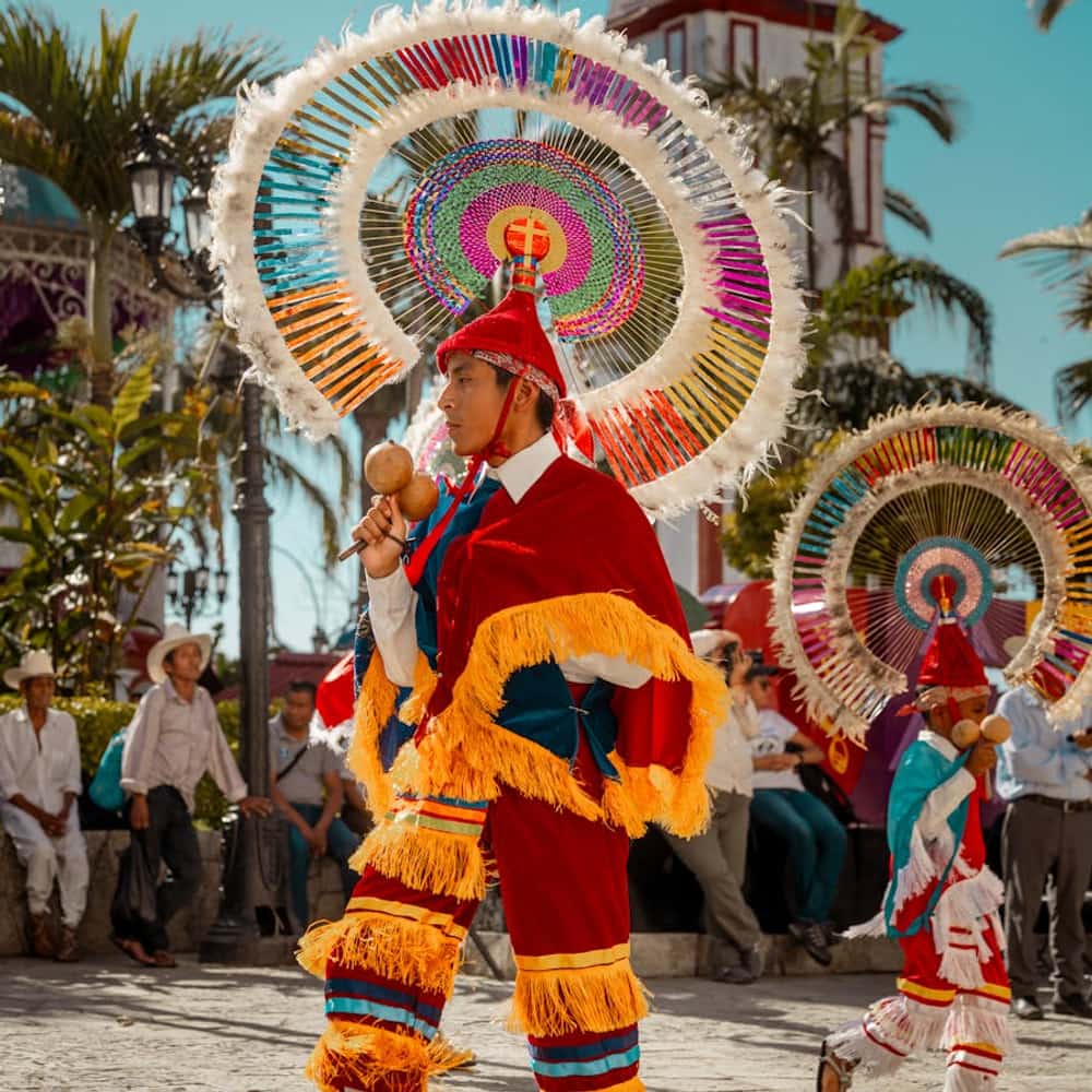 Cultural parade with performers in traditional Vietnamese conical hats during a daytime festival
